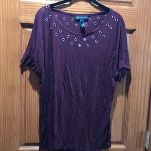 Woman’s short sleeved maroon INC top.
